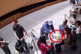 Pickpocket steals woman’s phone while she eats at restaurant.