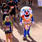 Members of the public finish during the 2021 Virgin Money London Marathon