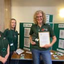 Lindsey Stockton (far right, holding framed document) with food bank colleagues