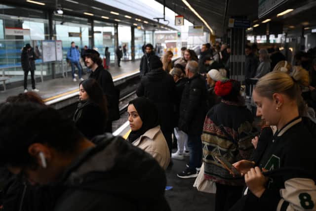 Commuters wait for an extremely delayed Central Line train at Stratford station in London on December 13 as rail strikes began a wave of festive walkouts in the country.