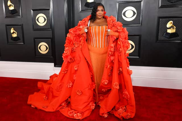 Singer Lizzo wore a statement floral gown from Dolce & Gabbana, complete with cape.