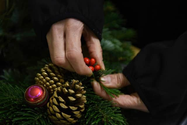 Putting finishing touches to a wreath