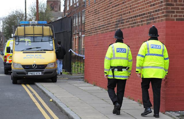 Police officers patrol the area around a house in Liverpool, north west England (PAUL ELLIS/AFP via Getty Images)