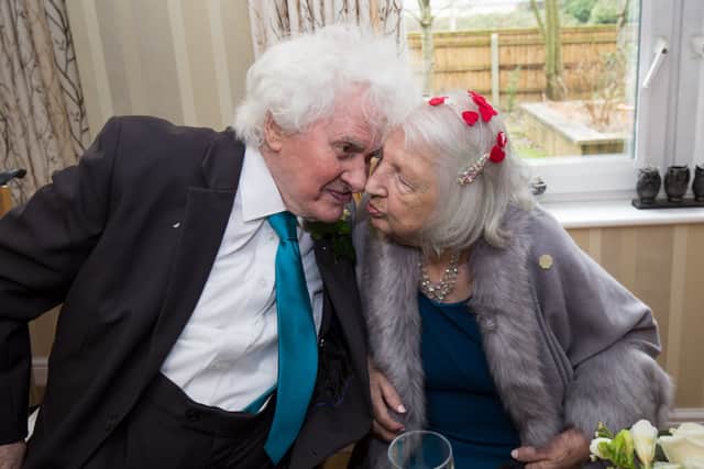 Joan Neininger & Ken Selway share a kiss at their wedding reception at Hannover Court, Cinderford, Gloucestershire.