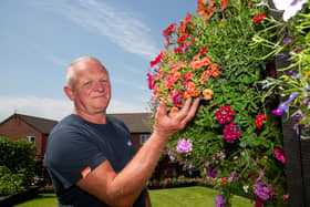 Shaun Schroeder, 59, plants around 140 hanging baskets and fence planters each year. 