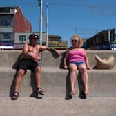 People enjoy the sunshine on the beach in Blackpool, north west England on June 14, 2023.