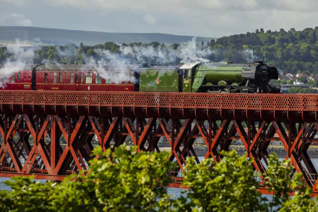 Flying Scotsman passes over the Forth Bridge as part of a series of events to celebrate her centenary. The world famous steam locomotive left Edinburgh before heading north to Aberdeen.