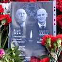 Sheet of paper with portraits of Yevgeny Prigozhin and Dmitry Utkin, a shadowy figure who managed Wagner’s operations and allegedly served in Russian military intelligence, is placed at a makeshift memorial in front of the Private Military Company (PMC) Wagner Centre in Saint Petersburg, on August 26.