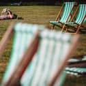 A man reads a book while sunbathing in Green Park in central London on September 5, 2023 as the country experiences a late heatwave. 