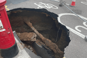 Mysterious sinkhole appears in UK and almost gobbles post box - motorists beware 