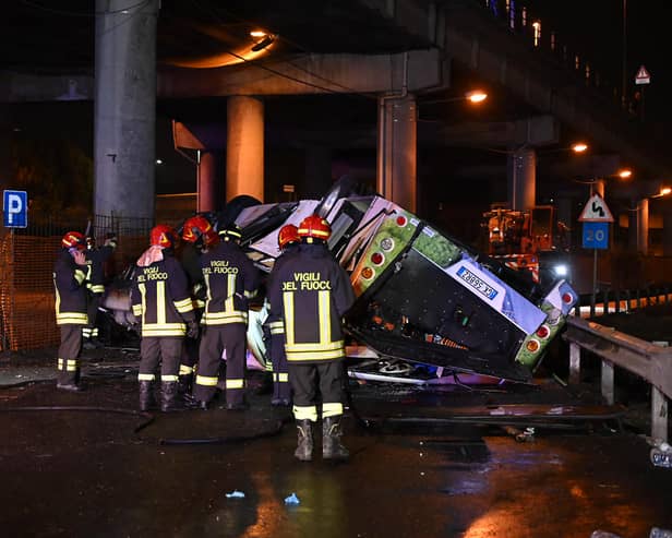 Firefighters work on the site of a bus accident on 3 October in Mestre, near Venice (Photo: MARCO SABADIN/AFP via Getty Images)