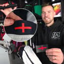Director Grant Walters at The Sports Shop in Kingswinford show off their St George's Cross transfer to apply to new England kit. A sports shop is selling St George’s Cross iron-on transfers for £4.95 - so fans can cover the controversial design on the new England football shirt. 