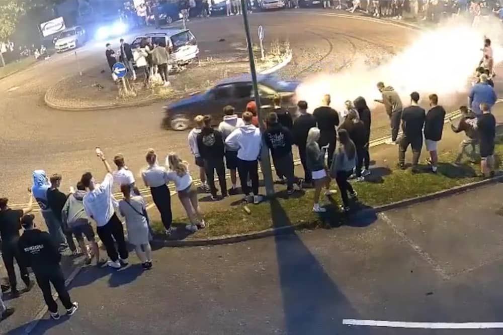 Driver does doughnuts at illegal car meet.