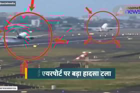 Plane takes off from runway seconds before inbound plane lands.