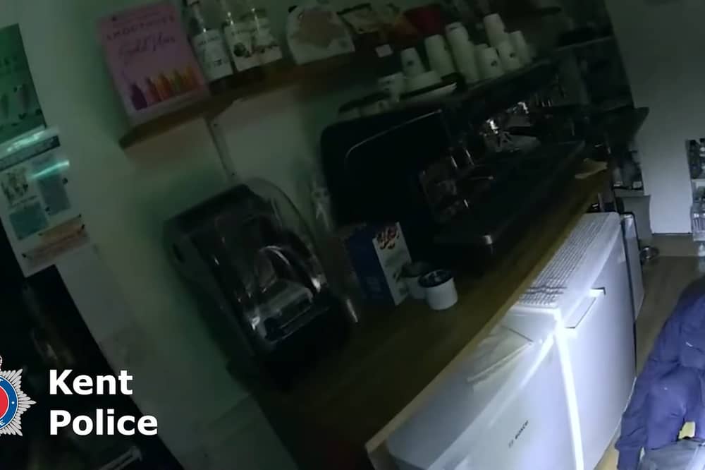 Burglar Stephen Clark found by police hiding under restaurant counter.