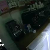 Burglar Stephen Clark found by police hiding under restaurant counter.