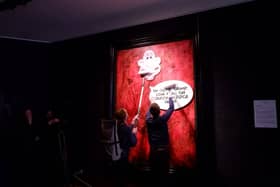 Protesters pasting over the royal portrait (Photo: Animal Rising/Supplied)