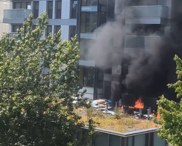 Fire rages at 22-storey tower block.