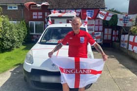 Martin Baker pictured outside his St George's flag covered home. 