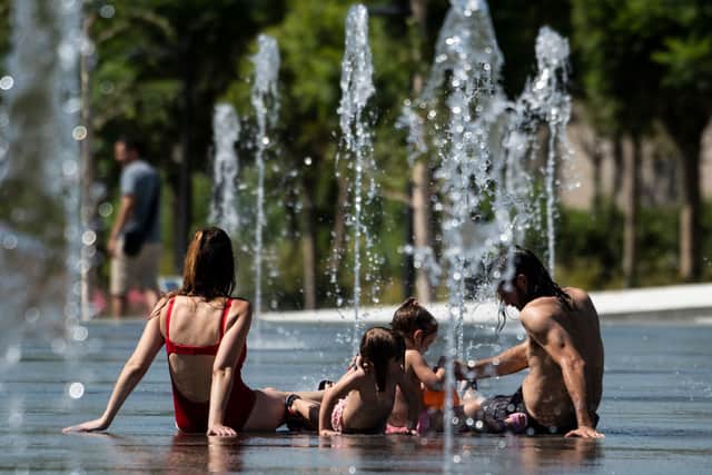 People cool off in water fountains amid a heatwave in Valencia in 2019 (Photo: JOSE JORDAN/AFP via Getty Images)