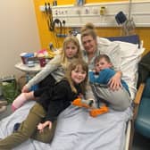 Lucy Woodhouse, 43, with her three children in hospital.