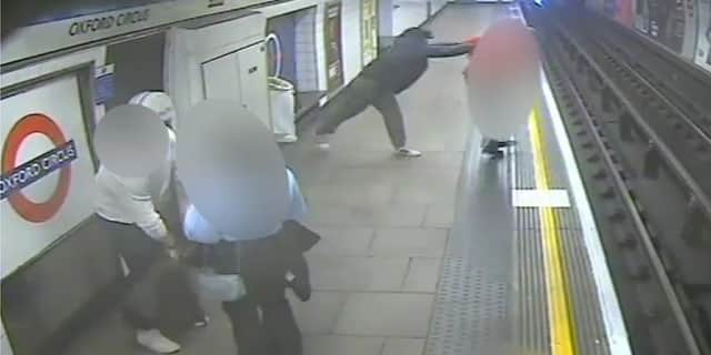 Man shoves stranger onto tracks as train arrives at platform.