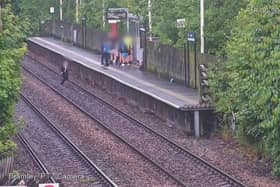 A child jumping onto the tracks in front of a train. 