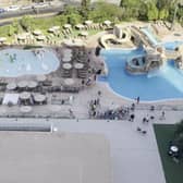 Tourists race to get sunbeds after queuing for pool to open.