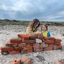 Heidi and Thea on the beach on Holy Island. Meet the family who live on an island that can only be accessed twice a day and only has five children in the local school. 