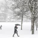 A member of the public walks through the snow in Victoria Park in Glasgow in February 2021 (Photo: ANDY BUCHANAN/AFP via Getty Images)