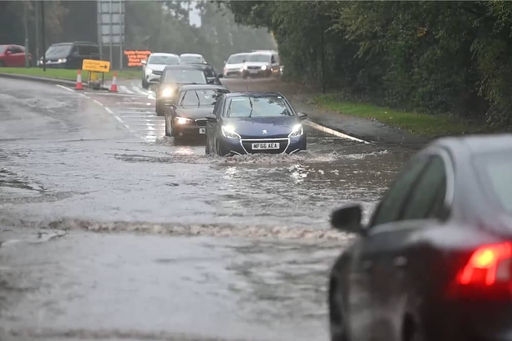 Drivers make their way through flooded roads.