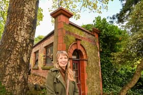 Loz Samuels pictured outside the world's smallest theatre - a former public loo in Malvern, UK.