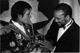 Michael Jackson, left, with Quincy Jones with armful of Grammys at the award show Feb. 28, 1984