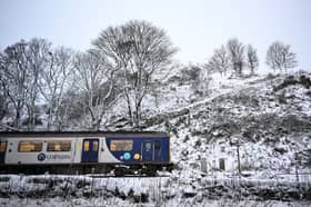 A Northern Rail train travels on tracks past snow in Buxton, northern England, on 19 November 2024 (Photo: PAUL ELLIS/AFP via Getty Images)
