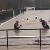 Lydney Town AFC players go swimming on their pitch.