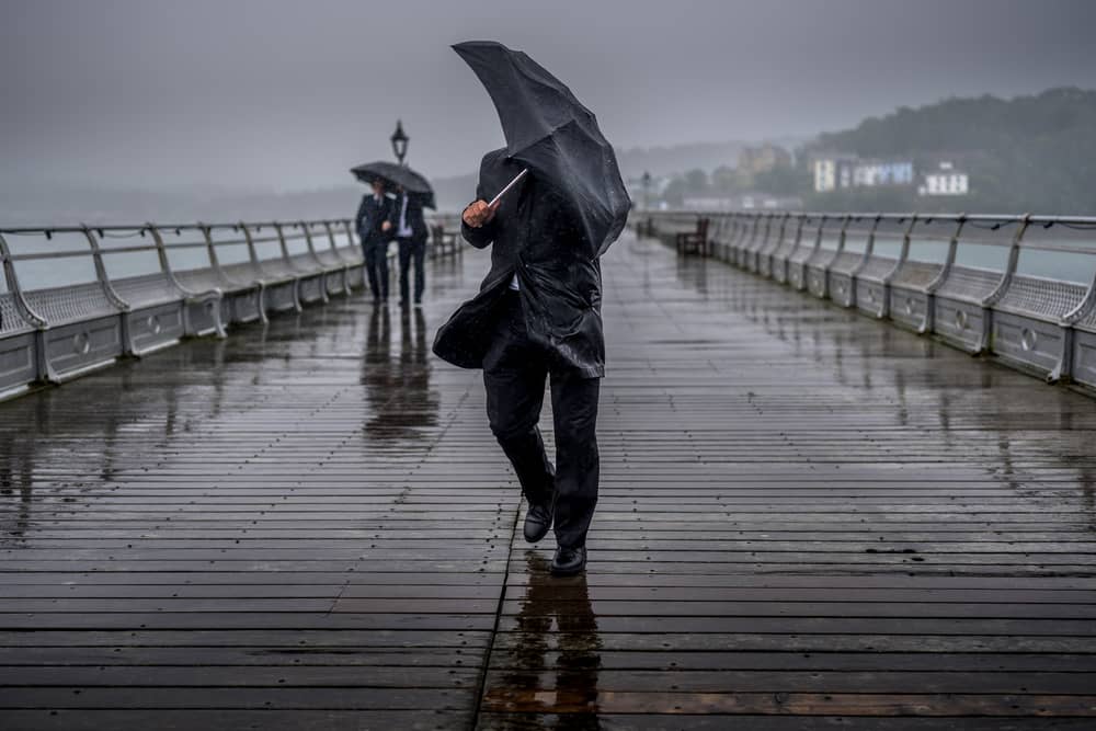 People battle against the wind and rain.