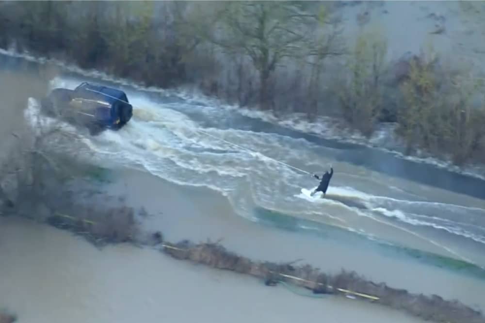 Man wakeboards along flooded road in Leicestershire.