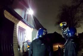 Police used a chainsaw to raid a drug house where they arrested a 13-year-old boy on suspicion of having a zombie knife. 