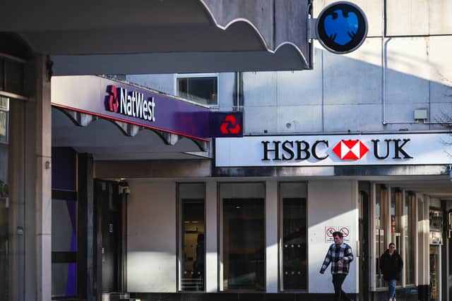 People walk pass a branches of HSBC, Natwest and Barclays banks on a pedestrianised shopping street in Bracknell town centre (Photo: ADRIAN DENNIS/AFP via Getty Images)