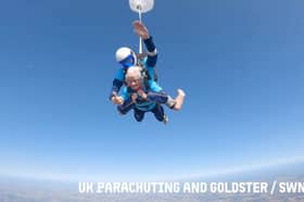 A 102-year-old lady skydiving with an instructor