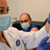 A nurse prepares to give a patient the mpox vaccine. 