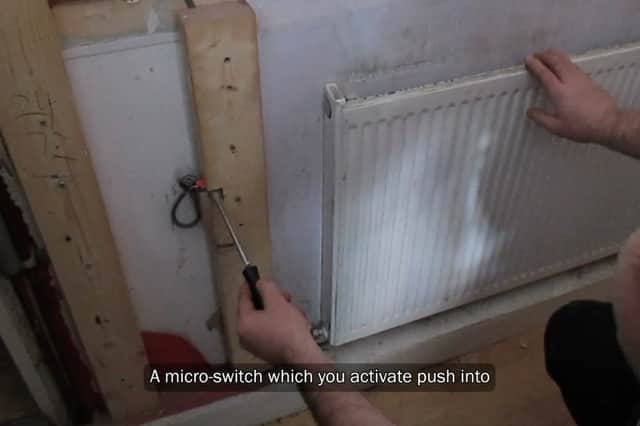 Law enforcement  begin to take apart a fake radiator which hid a stash illegal tobacco products.