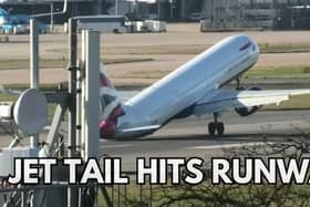 The tail of a plane hitting the ground while trying to land