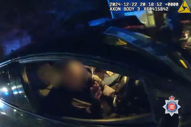 Drink driver caught drinking pint of beer at wheel of his car.