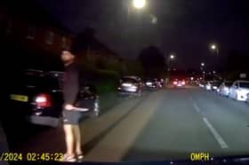 Murder victim drives away from his killer who is still grasping knife.