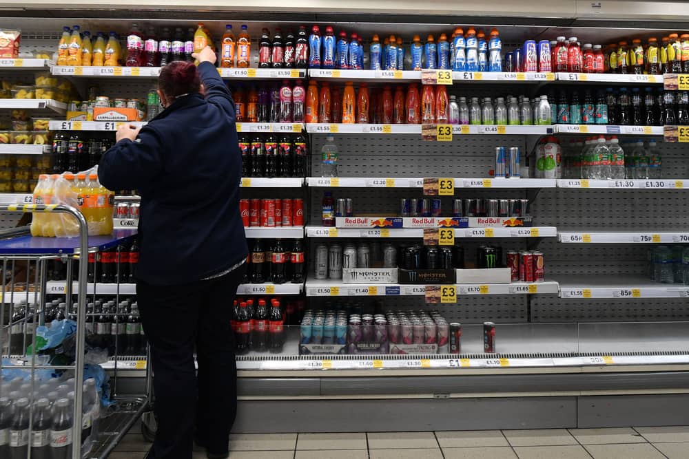 An employee stocks shelves at a Tesco supermarket in central London in 2021 (Photo: JUSTIN TALLIS/AFP via Getty Images)