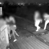 Men hold shut gates of level crossing in Barnsley, South Yorkshire.
