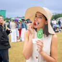 Tennis fan spotted dipping traditional strawberries into Dominos garlic and herd dip in the queue at Wimbledon