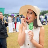Tennis fan spotted dipping traditional strawberries into Dominos garlic and herd dip in the queue at Wimbledon