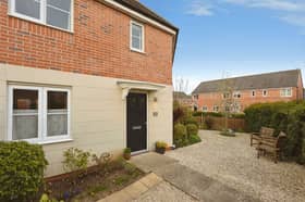 The attractive approach to this three-bedroom Melton Mowbray home includes a landscaped foregarden and screening hedge